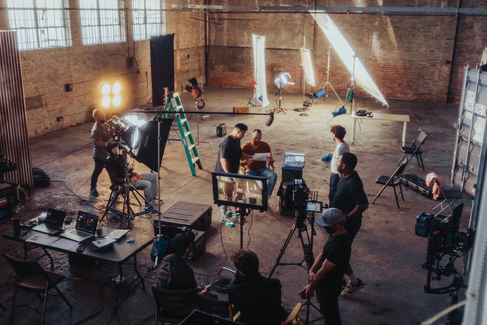 Film production crew gathered around a camera setup on a professional set