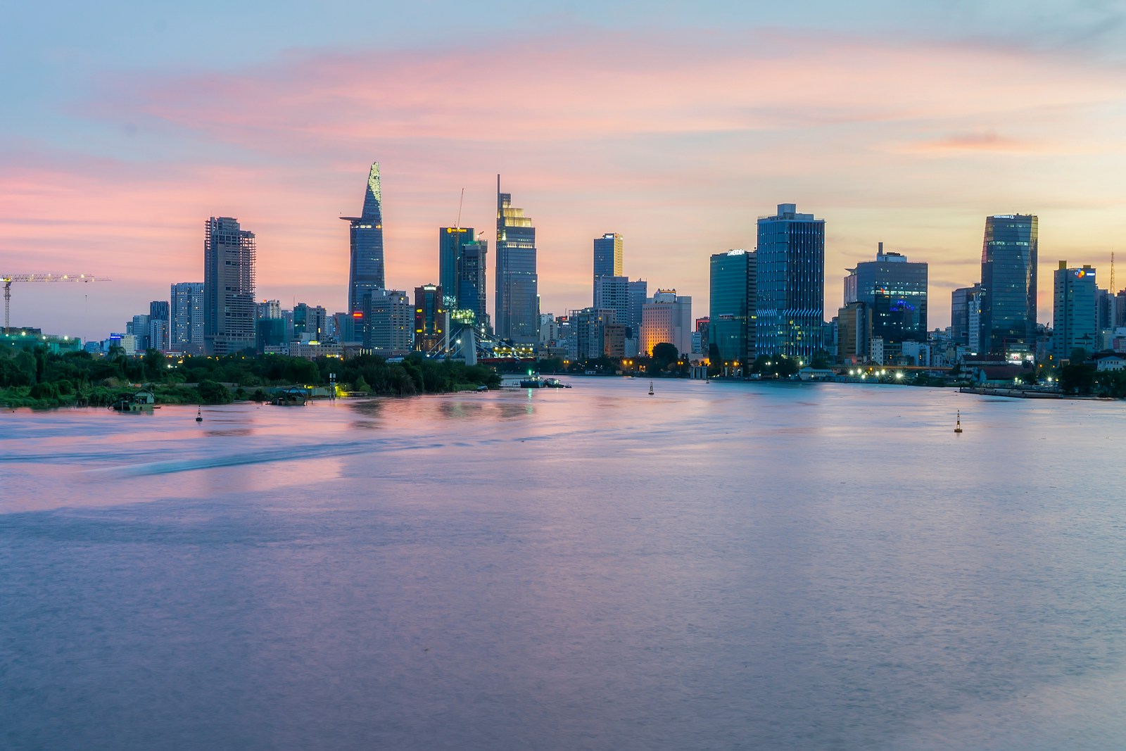 Ho Chi Minh City skyline across the Saigon River at sunset