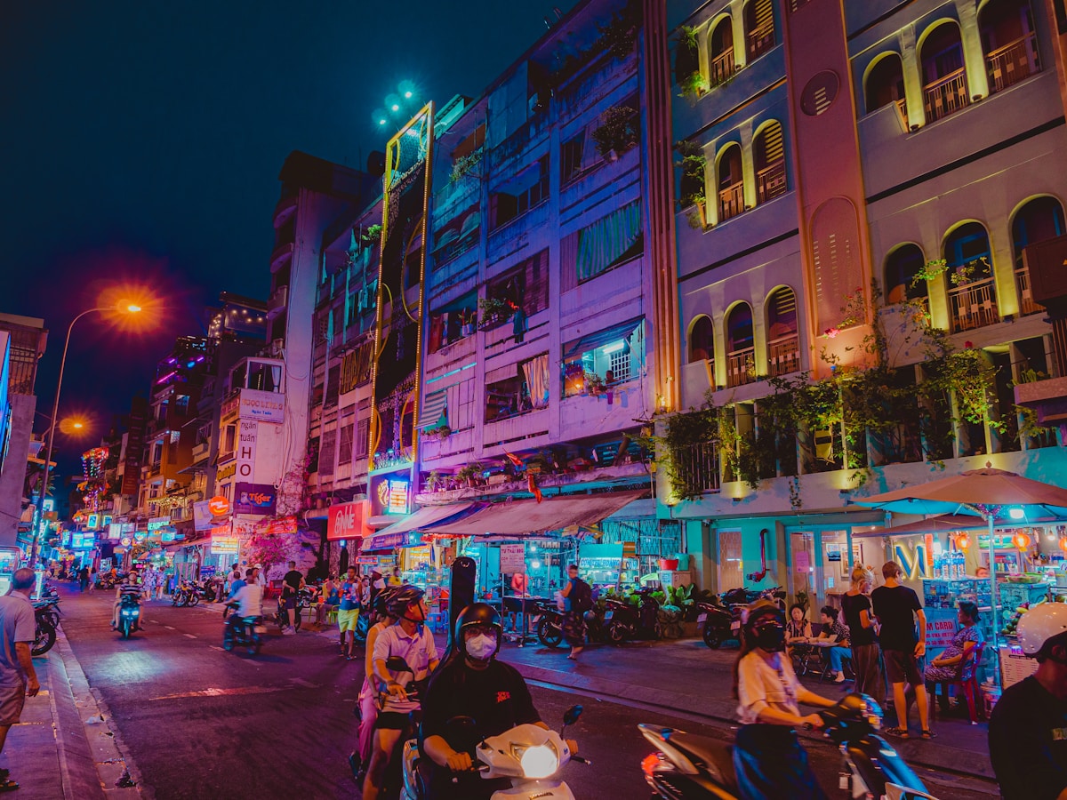 Illuminated street scene at night in a Vietnamese city