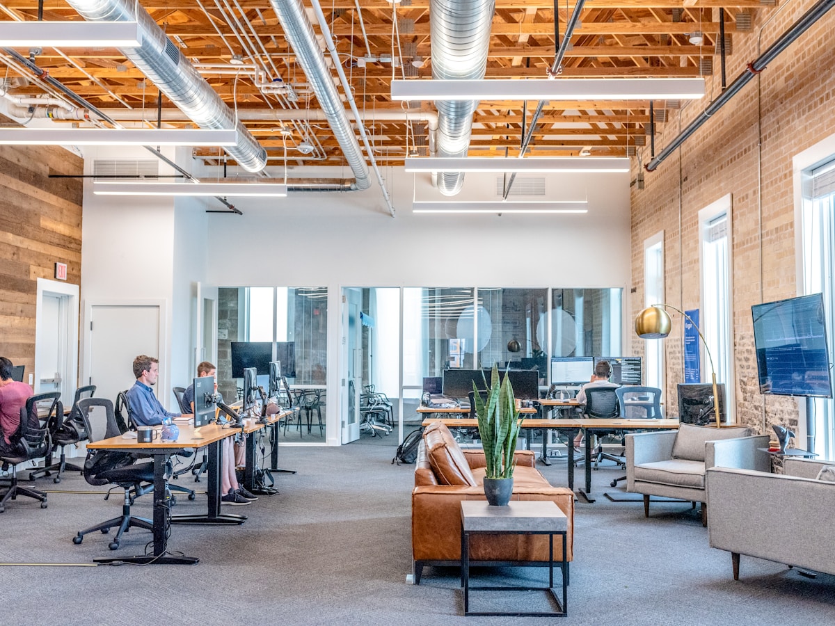 Media professional at a workspace with monitors, reviewing project details